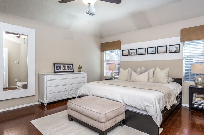 Bedroom featuring dark wood finished floors, ceiling fan, and vaulted ceiling | Image 21