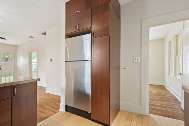 Kitchen with freestanding refrigerator, light wood-style flooring, light countertops, and brown cabinetry | Image 5