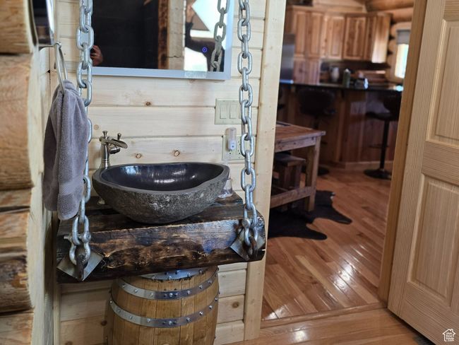 Room details featuring rustic walls, a sink, wooden ceiling, and wood finished floors | Image 87