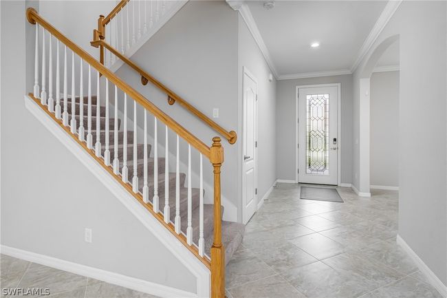 Entrance foyer featuring light tile floors and crown molding | Image 9