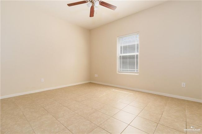 Unfurnished room with light tile patterned flooring and a ceiling fan | Image 5