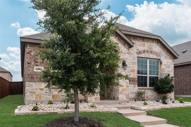 View of front of property with stone siding, roof with shingles, and brick siding | Image 4