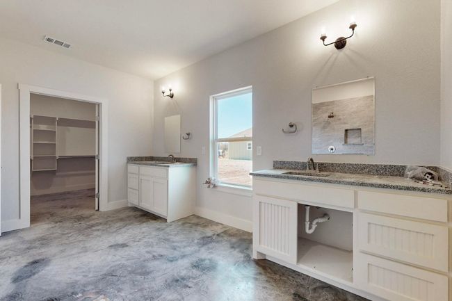 Full bath with two vanities, baseboards, visible vents, a shower, and a sink | Image 23