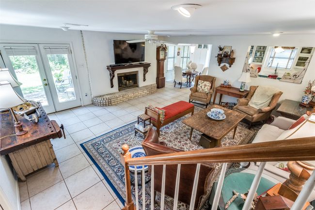 Living room featuring healthy amount of natural light, a fireplace, and light tile patterned flooring | Image 21