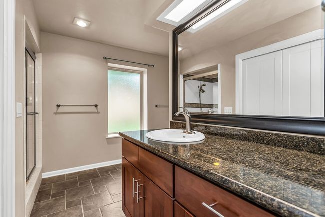 Bathroom with vanity and a shower stall | Image 19