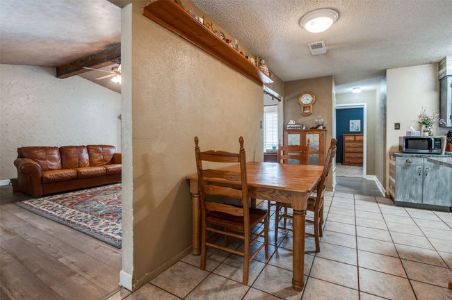 Dining area with visible vents, a textured wall, baseboards, ceiling fan, and a textured ceiling | Image 5
