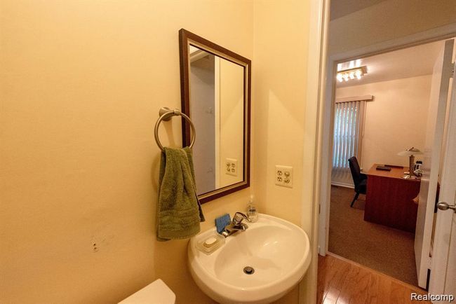 Half bathroom featuring wood finished floors and a sink | Image 30