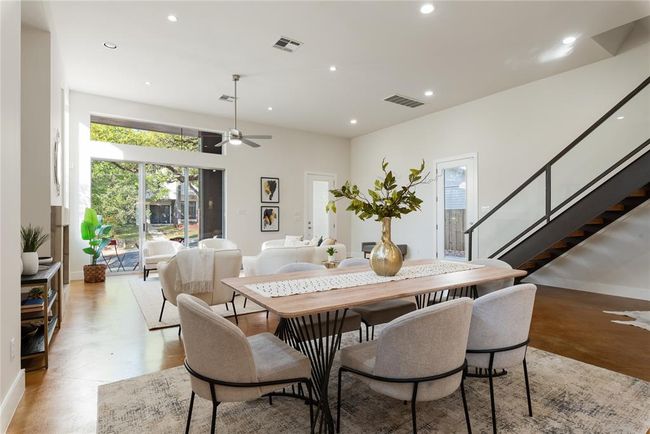 Dining area featuring recessed lighting, stairway, ceiling fan, baseboards, and concrete flooring | Image 13