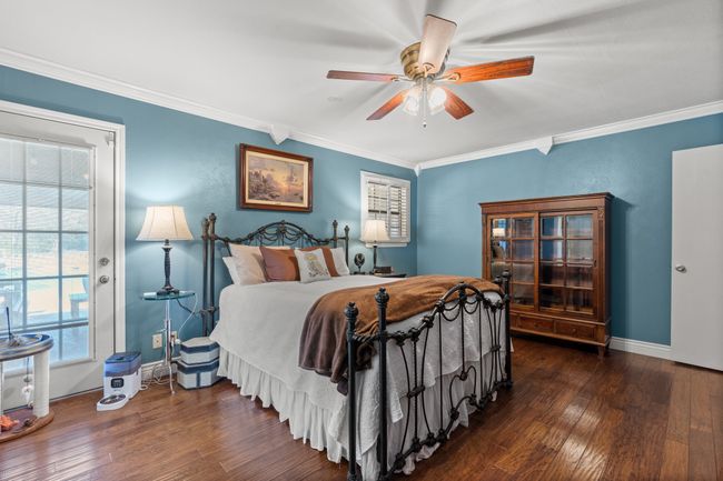 Primary Bedroom with ceiling fan, crown molding, and dark wood-type flooring | Image 25