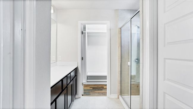 Bathroom with vanity, tile patterned floors, and a stall shower | Image 20