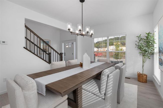 Dining space featuring a chandelier and light hardwood / wood-style floors | Image 17
