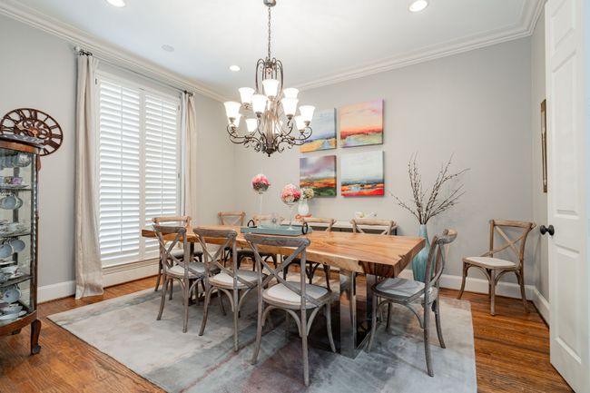 Dining room featuring baseboards, recessed lighting, a chandelier, and crown molding | Image 6