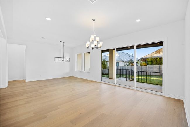 Empty room featuring a chandelier, light wood-style floors, and recessed lighting | Image 19