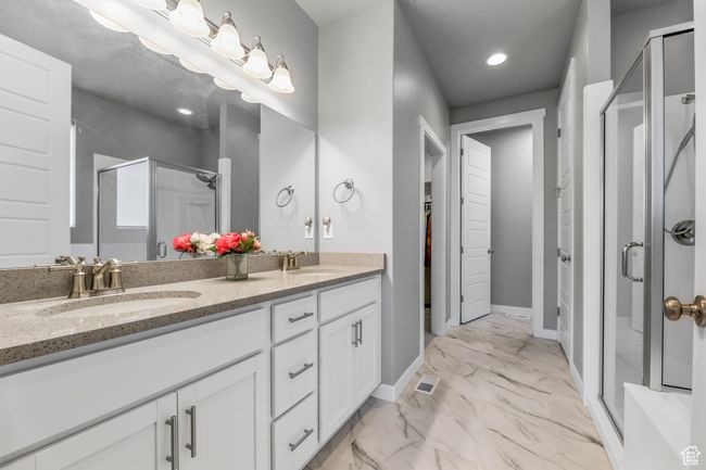 Full bathroom featuring marble finish floor, a sink, double vanity, and a stall shower | Image 21