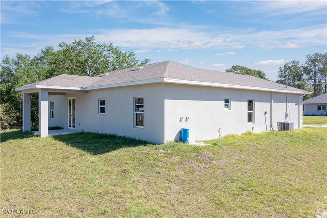 Back of property with central AC unit, stucco siding, and a yard | Image 20
