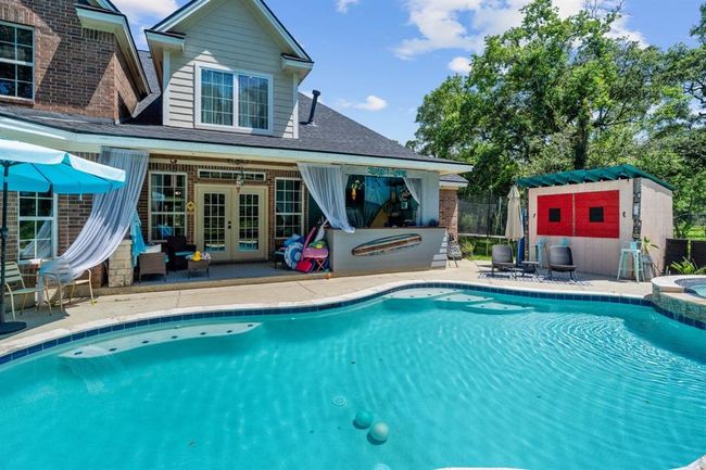 How about a dip in the pool? There is a bar area under the porch and a tiki bar to the right. | Image 39