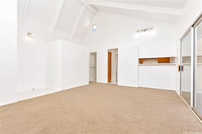 Looking across the living room. The entry door is on the left & kitchen pass through in the right. Where will you put your dining table? | Image 2