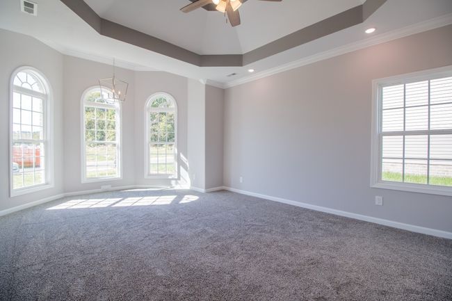 EXAMPLE>>>Primary Bedroom Features a Sitting Area, Double Tray Ceiling, Crown Molding and Recessed Lighting! | Image 9