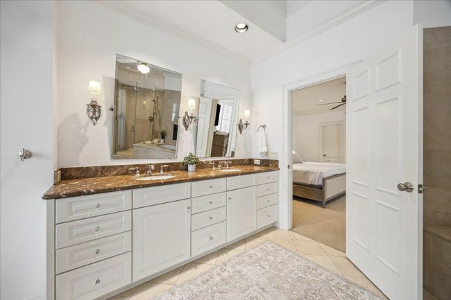Primary bathroom with dual vanities. Emperador marble counters. | Image 20