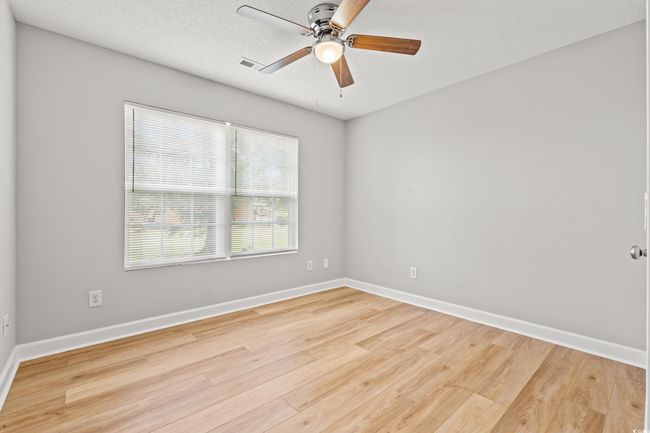 Unfurnished room featuring light wood-style floors, ceiling fan, and a textured ceiling | Image 20