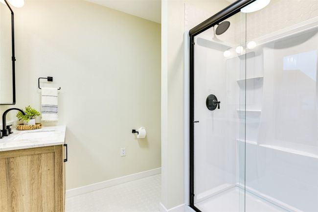 Full bath with a vanity and walk-in shower. | Image 39