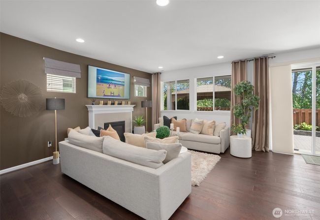 A cozy gas fireplace, designer-inspired paint and window coverings are featured in the main living areas! | Image 4