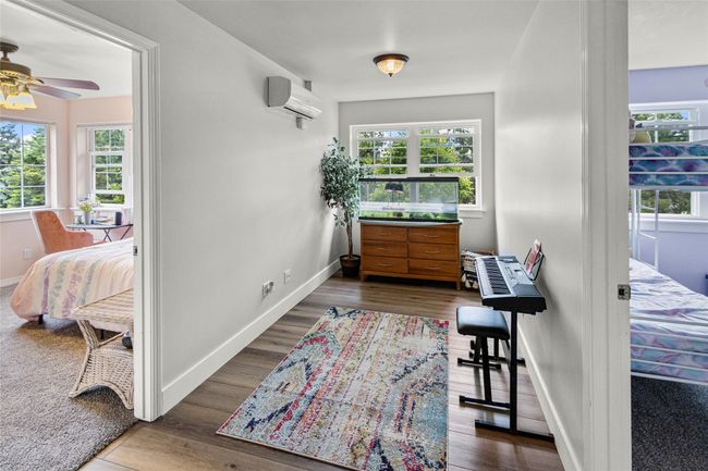 Corridor featuring a wall mounted AC, plenty of natural light, and dark wood-style flooring | Image 43