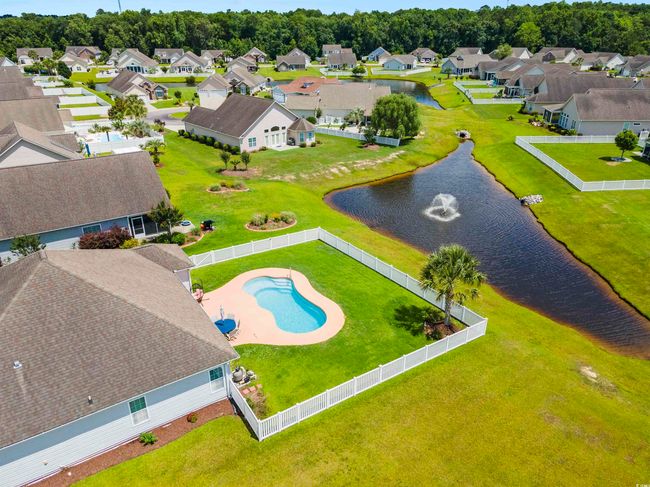 Aerial view of residential area with a nearby body of water and a pool area | Image 23