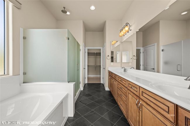 Full bath with a shower stall, a bath, a sink, tile patterned floors, and double vanity | Image 44