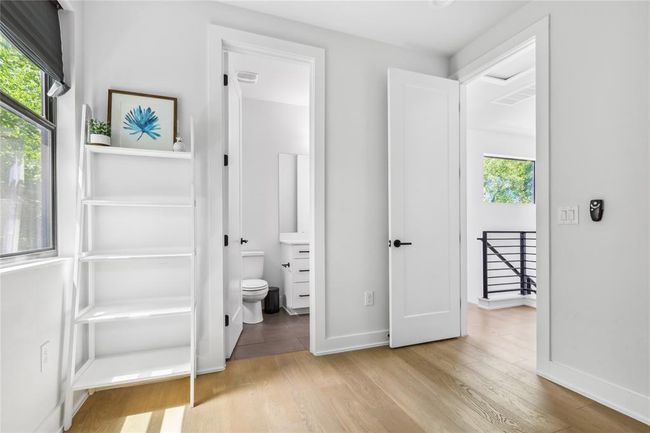 Unfurnished bedroom featuring wood finished floors and ensuite bathroom | Image 24