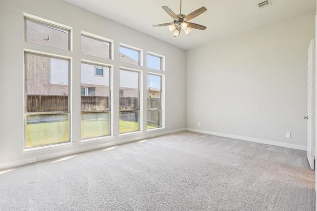 A spacious owner’s suite with large windows and plush carpet, offering a peaceful escape at the end of the day | Image 21