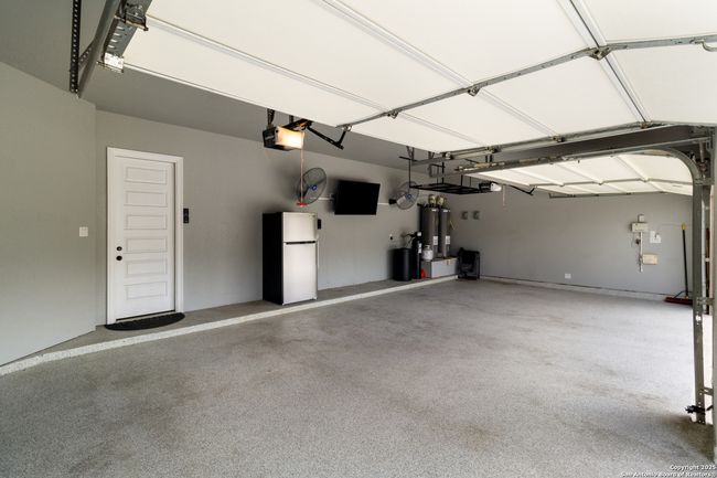 Spacious garage offering ample room for vehicles a | Image 28