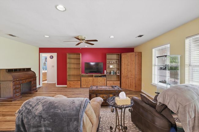 Living room featuring visible vents, baseboards, and a ceiling fan | Image 6