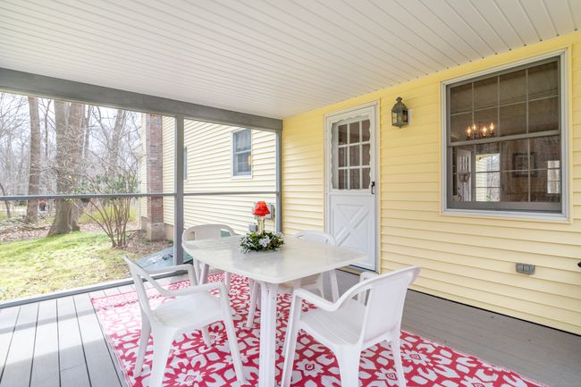 Enjoy cocktails (or reading...(you do you)) on the screened porch overlooking the private backyard | Image 15