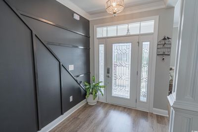 Foyer featuring a chandelier, light wood-type flooring, and ornamental molding | Image 3