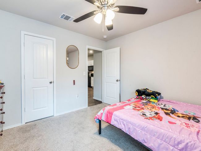 Carpeted bedroom with visible vents and a ceiling fan | Image 20