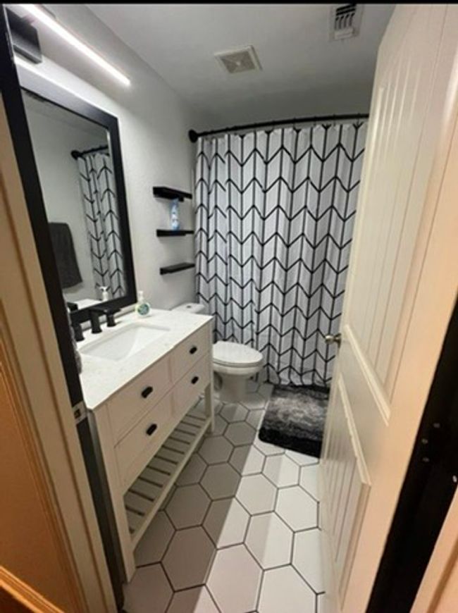 Bathroom featuring vanity, tile patterned floors, and a shower with curtain | Image 14