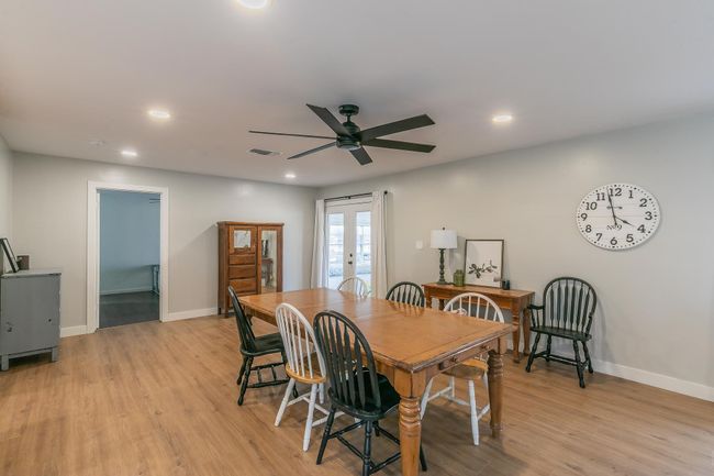 Dining area featuring ceiling fan, french doors, light wood finished floors, and recessed lighting | Image 10