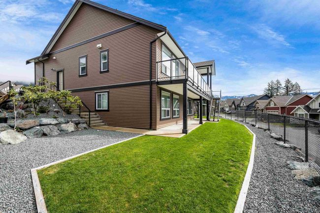 Rear view of house with a lawn, a residential view, a fenced backyard, and a patio area | Image 36