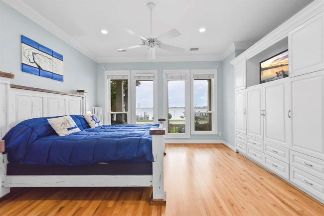 Discover elegant custom built-ins and beautiful hardwood floors throughout this charming home. | Image 23