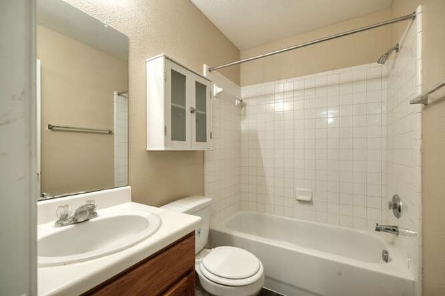Full bathroom featuring toilet, shower / bath combination, and vanity | Image 11