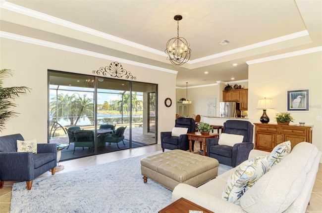 Great Room with Tray Ceiling and Crown Molding w/Tile Floors | Image 18