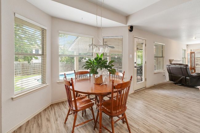 Breakfast nook that is open to the living room and has a nice pool view! | Image 8