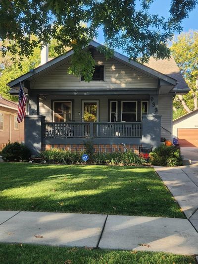 Bungalow-style home featuring a porch and a front lawn | Image 1