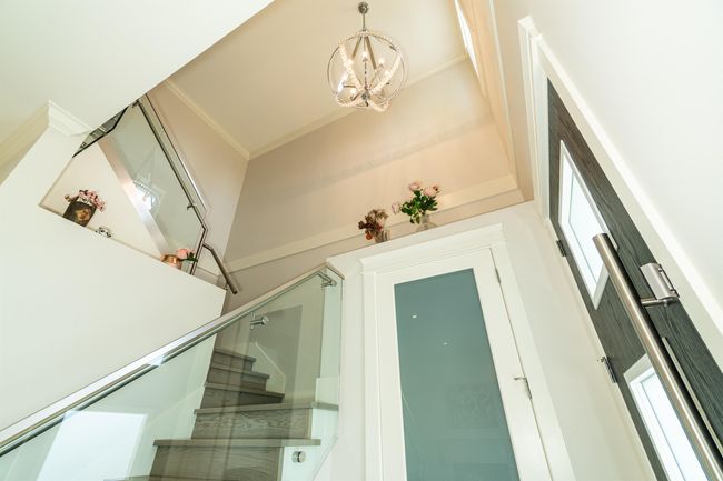 Stairway featuring a chandelier and crown molding | Image 6