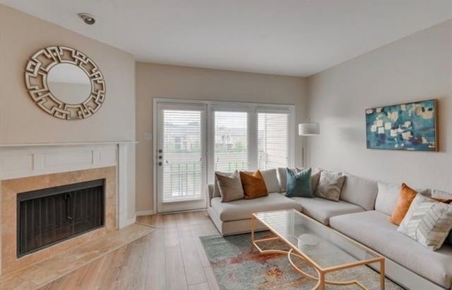 Living room with wood finished floors and a high end fireplace | Image 10
