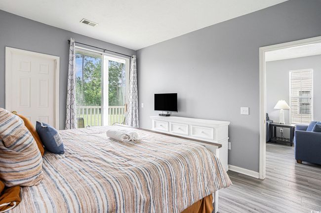 Bedroom with access to outside and wood finished floors | Image 13
