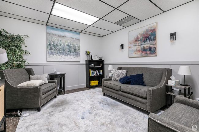 Living room with carpet floors and a drop ceiling | Image 13