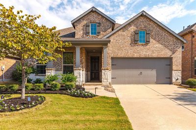 Craftsman-style house with a front yard and a garage | Image 2