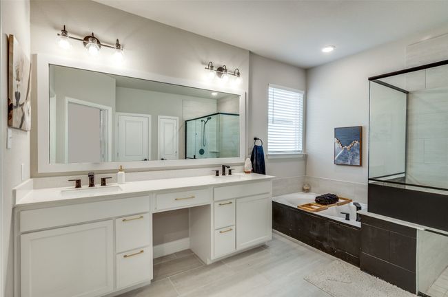 Full bathroom with double vanity, a bath, a sink, and a stall shower | Image 29